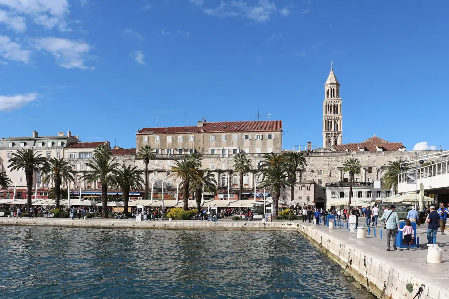 The waterfront of Split, with the palm-lined promenade and the bell tower of Diocletian's Palace